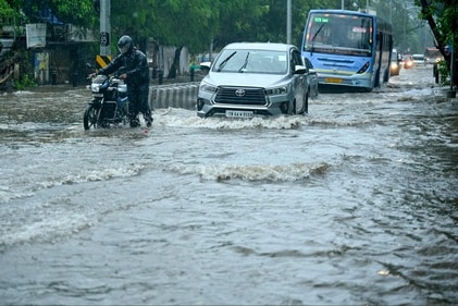 Commuters wade through a flooded street as it rains ahead of a cyclonic storm in Chennai on November 30, 2024. (AFP) Commuters wade through a flooded street as it rains ahead of a cyclonic storm in Chennai on November 30, 2024. (AFP)