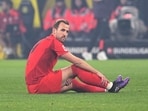 Bayern's Harry Kane sits on the pitch after getting injured. (Federico Gambarini/dpa/dpa via AP)