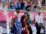 Pakistan's captain Babar Azam, right, and India's captain Rohit Sharma walk into the field Pakistan's captain Babar Azam, right, and India's captain Rohit Sharma walk into the field