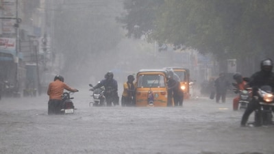 Commuters wade through a waterlogged road following heavy rainfall triggered by Cyclone Fengal, in Chennai on Saturday. (ANI) Commuters wade through a waterlogged road following heavy rainfall triggered by Cyclone Fengal, in Chennai on Saturday. (ANI)