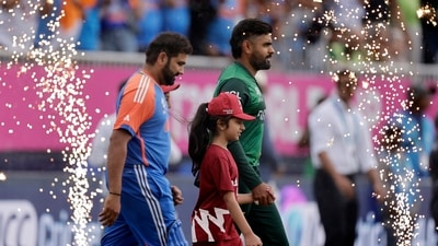 Pakistan's captain Babar Azam, right, and India's captain Rohit Sharma walk into the field (PTI) Pakistan's captain Babar Azam, right, and India's captain Rohit Sharma walk into the field (PTI)