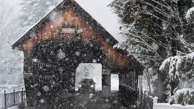 A motorist crosses a covered bridge during a snowstorm, Thursday, Nov. 28, 2024, in Woodstock, Vt. (AP Photo/Robert F. Bukaty) (AP) A motorist crosses a covered bridge during a snowstorm, Thursday, Nov. 28, 2024, in Woodstock, Vt. (AP Photo/Robert F. Bukaty) (AP)