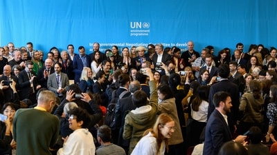 Delegates pose for a group photo at the end of a member state press briefing during the fifth meeting of the Intergovernmental Negotiating Committee to develop an international legally binding instrument on plastic pollution in Busan on Sunday. (AFP) (AFP)