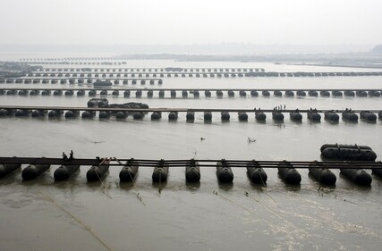 Labourers constructing a pontoon bridge ahead of the Maha Kumbh 2025, at the bank of Ganga in Prayagraj on Sunday. (ANI) Labourers constructing a pontoon bridge ahead of the Maha Kumbh 2025, at the bank of Ganga in Prayagraj on Sunday. (ANI)