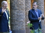 US President Joe Biden waves alongside his son Hunter Biden after attending mass at Holy Spirit Catholic Church in Johns Island.