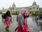 People wear hoodies to protect themselves from cold and moderate rain owing to Cyclone Fengal, near Vidhanasoudha in Bengaluru, Karnataka, People wear hoodies to protect themselves from cold and moderate rain owing to Cyclone Fengal, near Vidhanasoudha in Bengaluru, Karnataka,
