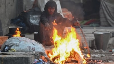 A man sits next to a bonfire on a cold winter morning in Noida on November 21. (Photo by Sunil Ghosh / Hindustan Times) A man sits next to a bonfire on a cold winter morning in Noida on November 21. (Photo by Sunil Ghosh / Hindustan Times)