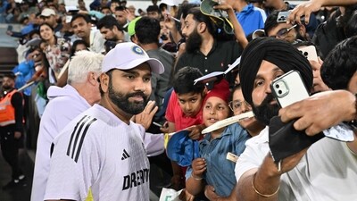 India captain Rohit Sharma takes pictures with fans at the Manuka Oval in Canberra. (AFP)