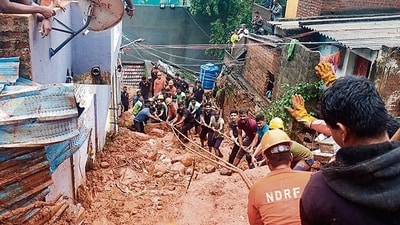 Rescue personnel remove debris after a landslide triggered by heavy rain in Tiruvannamalai on Monday. (AFP) Rescue personnel remove debris after a landslide triggered by heavy rain in Tiruvannamalai on Monday. (AFP)