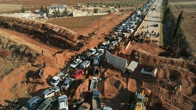 The photo shows people crossing an anti-government checkpoint as return to the town of Saraqib in the eastern part of the Idlib province in northwestern Syria. This marks the fifth day since the takeover. Russian and Iranian backed militias have also entered Syria to fight the rebels. (AFP) The photo shows people crossing an anti-government checkpoint as return to the town of Saraqib in the eastern part of the Idlib province in northwestern Syria. This marks the fifth day since the takeover. Russian and Iranian backed militias have also entered Syria to fight the rebels. (AFP)