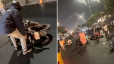 In a video, men and women were seen sprawled on the road along with their fallen two-wheelers. (X/@InformedAlerts) In a video, men and women were seen sprawled on the road along with their fallen two-wheelers. (X/@InformedAlerts)
