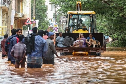 People move through a flooded street after heavy rainfall in Puducherry on December 1, 2024, following the landfall of cyclone Fengal. (AFP) People move through a flooded street after heavy rainfall in Puducherry on December 1, 2024, following the landfall of cyclone Fengal. (AFP)