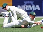 Australia's Marnus Labuschagne, right, reaches out for the ball as he and teammate Steve Smith attempt to field the ball. (AP Photo/Trevor Collens) Australia's Marnus Labuschagne, right, reaches out for the ball as he and teammate Steve Smith attempt to field the ball. (AP Photo/Trevor Collens)