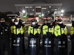 TOPSHOT - Police stand guard in front of the main gate of the National Assembly in Seoul on December 3, 2024, after South Korea's President Yoon Suk Yeol declared emergency martial law. South Korea's President Yoon Suk Yeol on December 3 declared emergency martial law, saying the step was necessary to protect the country from "communist forces" amid parliamentary wrangling over a budget bill. (Photo by Jung Yeon-je / AFP)