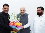 Union minister Amit Shah, Maharashtra BJP leader Devendra Fadnavis, Shiv Sena leader Eknath Shinde exchange greetings during a meeting.