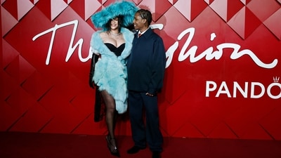 Pop star Rihanna arrived at the British Fashion Awards fashionably late in a fluffy pale blue coat. She was joined by her partner A$AP Rocky, who was given the award for Cultural Innovator. While A$AP wore a Bottega Veneta navy blue suit, Rihanna complemented him in a black figure-sculpting dress, sheer stockings, embellished heels, black Opera gloves, and a fluffy blue hat. (AFP) Pop star Rihanna arrived at the British Fashion Awards fashionably late in a fluffy pale blue coat. She was joined by her partner A$AP Rocky, who was given the award for Cultural Innovator. While A$AP wore a Bottega Veneta navy blue suit, Rihanna complemented him in a black figure-sculpting dress, sheer stockings, embellished heels, black Opera gloves, and a fluffy blue hat. (AFP)
