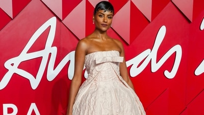 Simone Ashley made a dazzling appearance on the British Fashion Awards red carpet in a Prada ensemble. She wore a blush pink strapless gown featuring a voluminous mini-length skirt, a crushed silk design, and a floor-sweeping train attached on the back. She wore silver stilettos, diamond jewels, minimal glam, and a sleek hairdo to style the ensemble. (Scott A Garfitt/Invision/AP) Simone Ashley made a dazzling appearance on the British Fashion Awards red carpet in a Prada ensemble. She wore a blush pink strapless gown featuring a voluminous mini-length skirt, a crushed silk design, and a floor-sweeping train attached on the back. She wore silver stilettos, diamond jewels, minimal glam, and a sleek hairdo to style the ensemble. (Scott A Garfitt/Invision/AP)