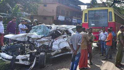Locals gather near the wreckage of a car that collided with a Kerala State Road Transport Corporation (KSRTC) bus on Monday night, in Alappuzha, Kerala, Tuesday (PTI) Locals gather near the wreckage of a car that collided with a Kerala State Road Transport Corporation (KSRTC) bus on Monday night, in Alappuzha, Kerala, Tuesday (PTI)