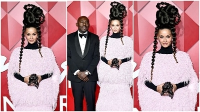 Natasha Poonawalla turned heads at the British Fashion Awards in a blush pink Moncler Genius ensemble from the label's 2024 Fall collection. She styled the ensemble with black block heel boots, a black full-sleeved turtleneck, a black statement clutch, and diamond earrings. The highlight of her red carpet look was the hairstyle featuring multiple bubble braids styled on top of her head and framing her face. Natasha Poonawalla turned heads at the British Fashion Awards in a blush pink Moncler Genius ensemble from the label's 2024 Fall collection. She styled the ensemble with black block heel boots, a black full-sleeved turtleneck, a black statement clutch, and diamond earrings. The highlight of her red carpet look was the hairstyle featuring multiple bubble braids styled on top of her head and framing her face.