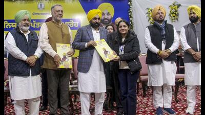 Punjab chief minister Bhagwant Mann with health minister Balbir Singh during distribution of appointment letters to newly inducted recruits in the state health department, in Patiala, Tuesday. (PTI)