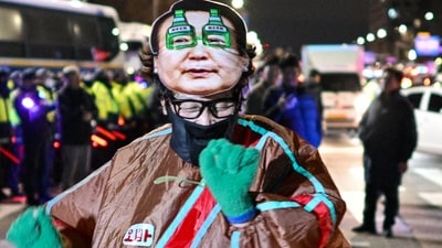 A man wearing an outfit with a face mask of South Korea's President Yoon Suk Yeol dances outside the National Assembly in Seoul, South Korea on December 4, 2024, after Yoon declared martial law. (AFP) A man wearing an outfit with a face mask of South Korea's President Yoon Suk Yeol dances outside the National Assembly in Seoul, South Korea on December 4, 2024, after Yoon declared martial law. (AFP)