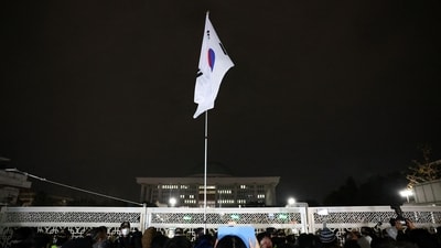 South Korean flag hangs on a pole outside the gate of the National Assembly, after President Yoon Suk Yeol declared martial law, (Reuters)