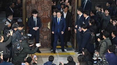 South Korea's main opposition Democratic Party leader Lee Jae-myung (C) walks out from the main conference hall of the National Assembly in Seoul. (AFP)
