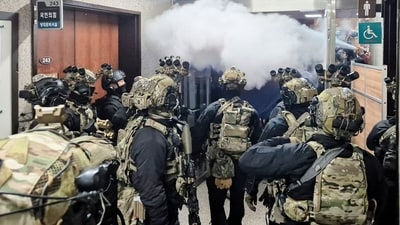 Soldiers try to enter the main hall of the National Assembly after South Korea President Yoon Suk Yeol declared martial law.&nbsp; (AFP)