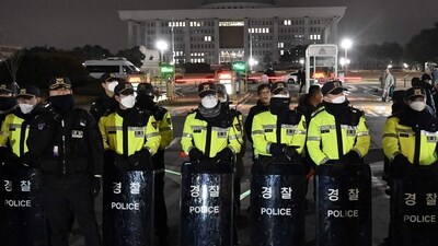 Police stand guard in front of the main gate of the National Assembly in Seoul on December 3, 2024,&nbsp; (AFP)