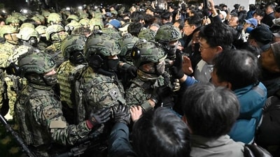 Soldiers try to enter the National Assembly building in Seoul on December 4 2024, after South Korea President Yoon Suk Yeol declared martial law.&nbsp; (AFP)