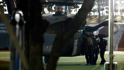 Soldiers disembark from a helicopter in a yard of the National Assembly in Seoul. (AFP)