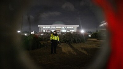 A police officer stands guard outside the National Assembly in Seoul on December 4, 2024. (AFP)