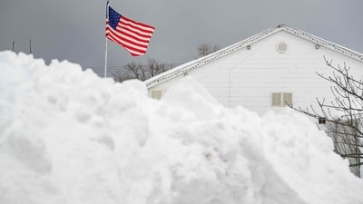 - DECEMBER 2:The flag flies over the Lawrence Athletic Club in front of a mountain of snow after a record snowfall left over 3 feet on the ground on December 2, 2024 in Erie,. (Getty Images via AFP)