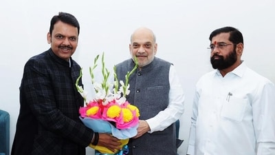 Union minister Amit Shah, Maharashtra BJP leader Devendra Fadnavis, Shiv Sena leader Eknath Shinde exchange greetings during a meeting. (PTI file photo)
