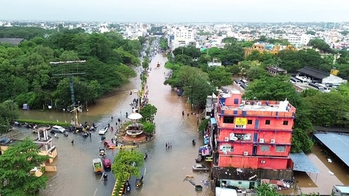 Vehicles and people wade through a flooded road amid heavy rainfall triggered by Cyclone Fengal, in Puducherry on Sunday. (ANI) Vehicles and people wade through a flooded road amid heavy rainfall triggered by Cyclone Fengal, in Puducherry on Sunday. (ANI)
