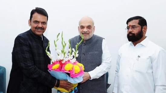 Union minister Amit Shah, Maharashtra BJP leader Devendra Fadnavis, Shiv Sena leader Eknath Shinde exchange greetings during a meeting. (PTI file photo)