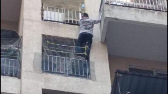 When police broke open the door to the 10th floor apartment, they found the accused hanging dangerously from the balcony, trying to jump to another balcony