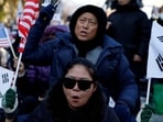 Protesters from conservative groups shout slogans at a rally supporting South Korean President Yoon Suk Yeol and denouncing opposition party's politicians after the President's surprise declaration of the martial law last night, which was reversed hours later in Seoul, South Korea, 