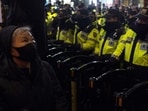 A woman looks up near a police barricade with rows of police officers blocking a protest march to the presidential office after a candlelight vigil against South Korean President Yoon Suk Yeol, in Seoul, South Korea, Wednesday, Dec. 4, 2024 (AP Photo/Ng Han Guan) A woman looks up near a police barricade with rows of police officers blocking a protest march to the presidential office after a candlelight vigil against South Korean President Yoon Suk Yeol, in Seoul, South Korea, Wednesday, Dec. 4, 2024 (AP Photo/Ng Han Guan)