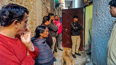 New Delhi: Police personnel and others at a house at Neb Sarai area where a middle-aged couple and their daughter were found dead. (PTI)