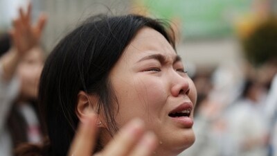 A woman cries while praying during a massive worship service in protest of the legislation of anti-discrimination bills and same-sex relationships, in central Seoul. (REUTERS)