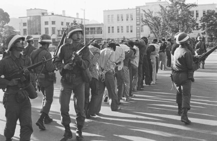 Armed South Korean government martial law troops guard captured rebels in Gwangju (Kwangju), South Korea, on May 27, 1980. The rebels were rounded up following the government's recapture by the riot-battered city. (AP) Armed South Korean government martial law troops guard captured rebels in Gwangju (Kwangju), South Korea, on May 27, 1980. The rebels were rounded up following the government's recapture by the riot-battered city. (AP)