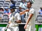 Australia's paceman Mitchell Starc reacts as India's Yashasvi Jaiswal (L) fails to play a shot