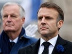 French President Emmanuel Macron, right, and Prime Minister Michel Barnier stand at attention during commemorations marking the 106th anniversary of the November 11, 1918, Armistice, ending World War I, at the Arc de Triomphe in Paris, Monday, Nov. 11, 2024.