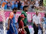 Pakistan's Babar Azam, right, and India's captain Rohit Sharma walk into the field Pakistan's Babar Azam, right, and India's captain Rohit Sharma walk into the field