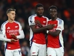 Arsenal's Leandro Trossard, Thomas Partey and Bukayo Saka celebrate after the match