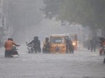 Commuters wade through a waterlogged road following heavy rainfall triggered by Cyclone Fengal, in Chennai on Saturday. Commuters wade through a waterlogged road following heavy rainfall triggered by Cyclone Fengal, in Chennai on Saturday.