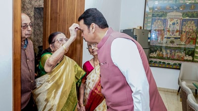 BJP leader Devendra Fadnavis shared a picture of him taking blessings from his mother Sarita Fadnavis ahead of his oath-taking ceremony as chief minister of Maharashtra today (Devendra Fadnavis/X) BJP leader Devendra Fadnavis shared a picture of him taking blessings from his mother Sarita Fadnavis ahead of his oath-taking ceremony as chief minister of Maharashtra today (Devendra Fadnavis/X)