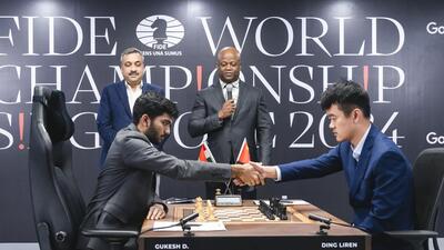 India's D Gukesh and China’s Ding Liren exchange greetings during the ninth game of the World Chess Championship. (PTI)
