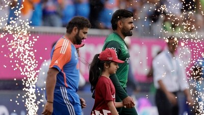 Pakistan's Babar Azam, right, and India's captain Rohit Sharma walk into the field (PTI) Pakistan's Babar Azam, right, and India's captain Rohit Sharma walk into the field (PTI)